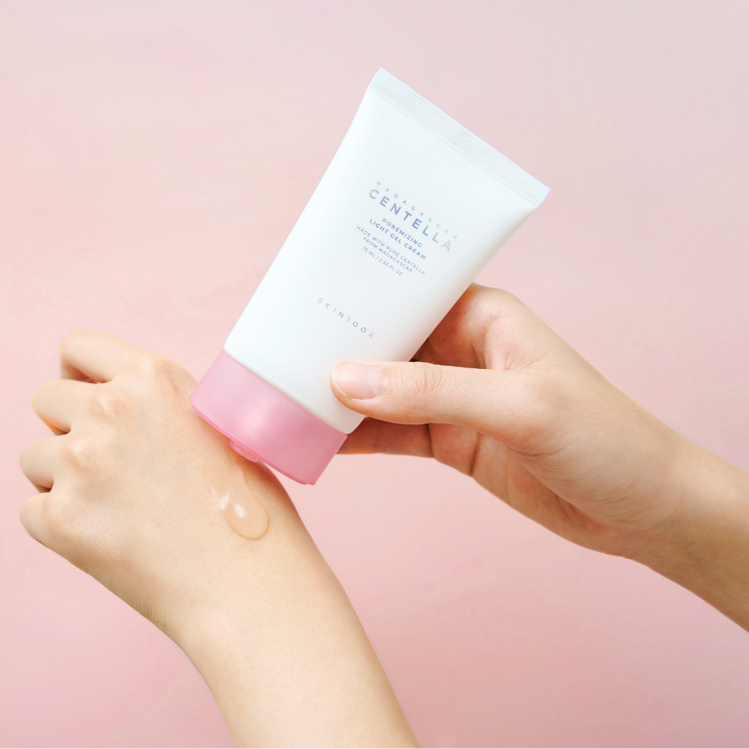 moel displaying the SKIN 1004 premizing light gel cream on the models hand 