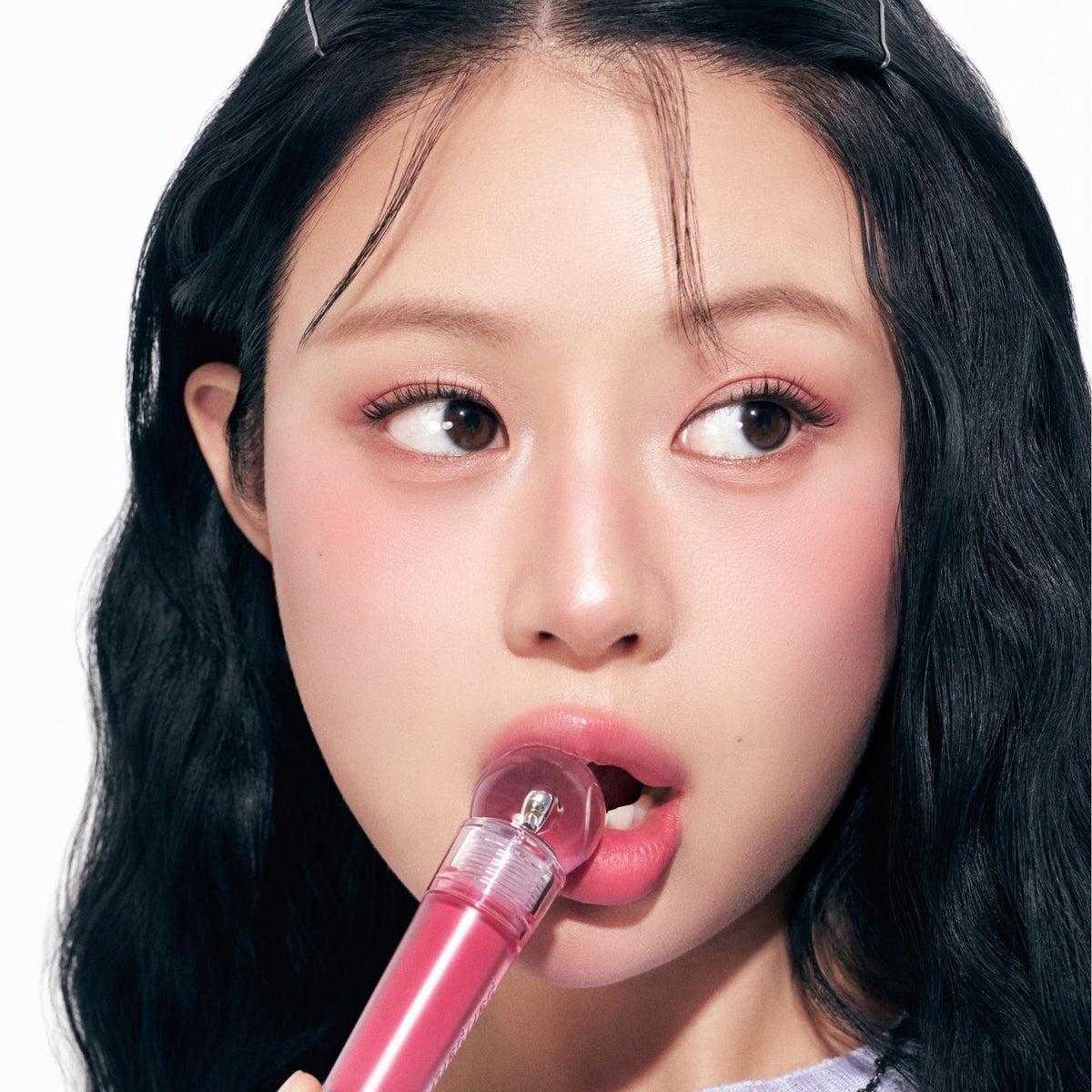 Peripera Ink Jellable Lip Tint in a vibrant shade, showing the glossy, gel-like texture applied on lips.