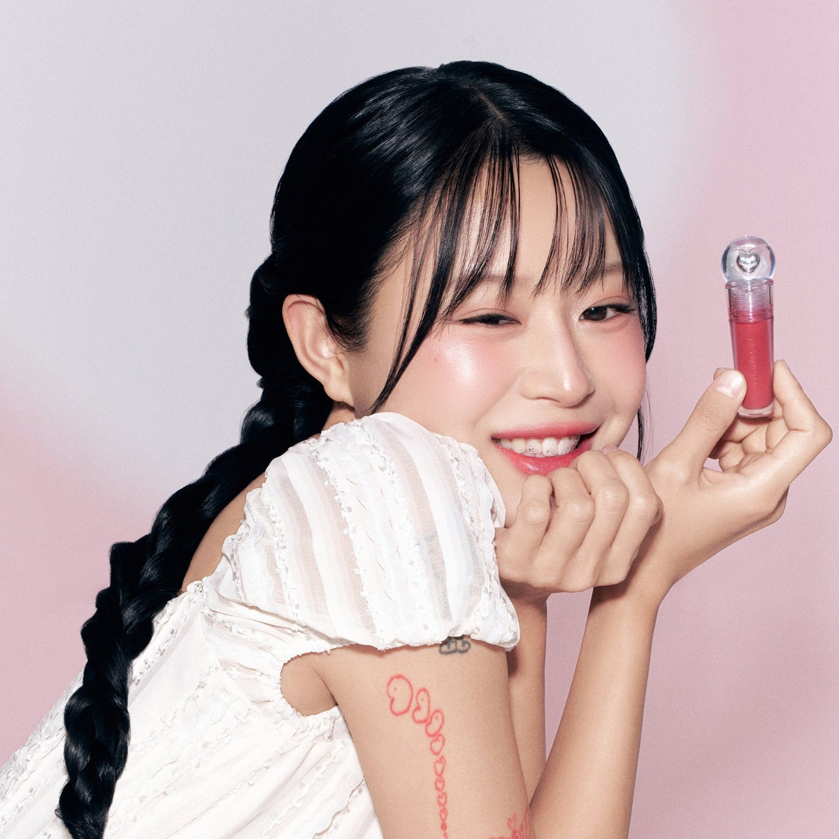 Peripera Ink Jellable Lip Tint in a vibrant shade, showcasing the glossy, jelly-like texture and applicator brush.