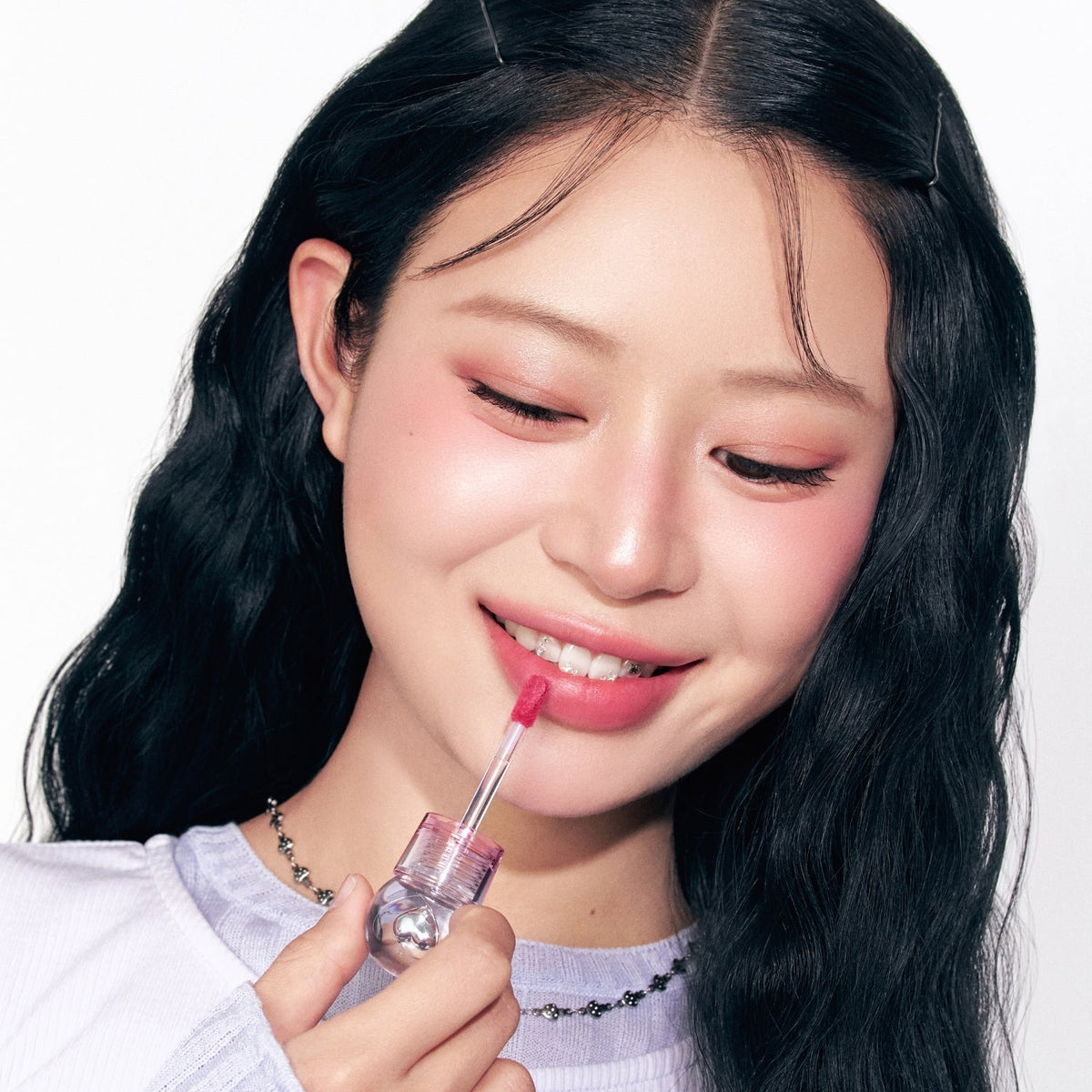 Peripera Ink Jellable Lip Tint in a sleek tube with a doe-foot applicator, showcasing the vibrant pink shade.