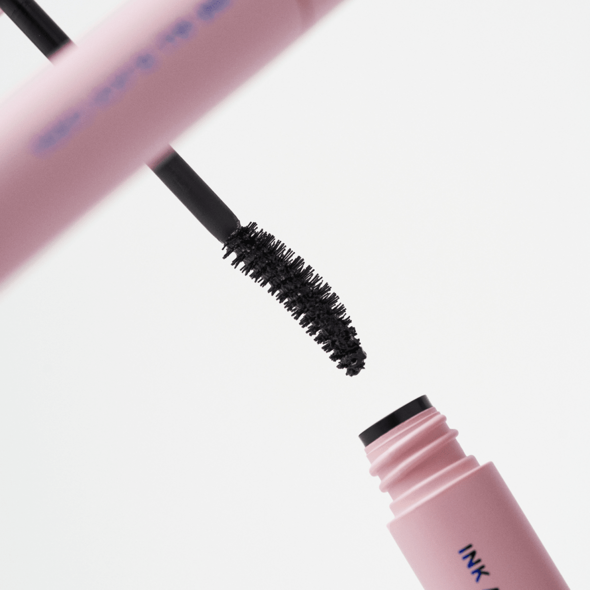 Peripera Ink All Black Cara mascara brush with black mascara for bold, defined lashes.