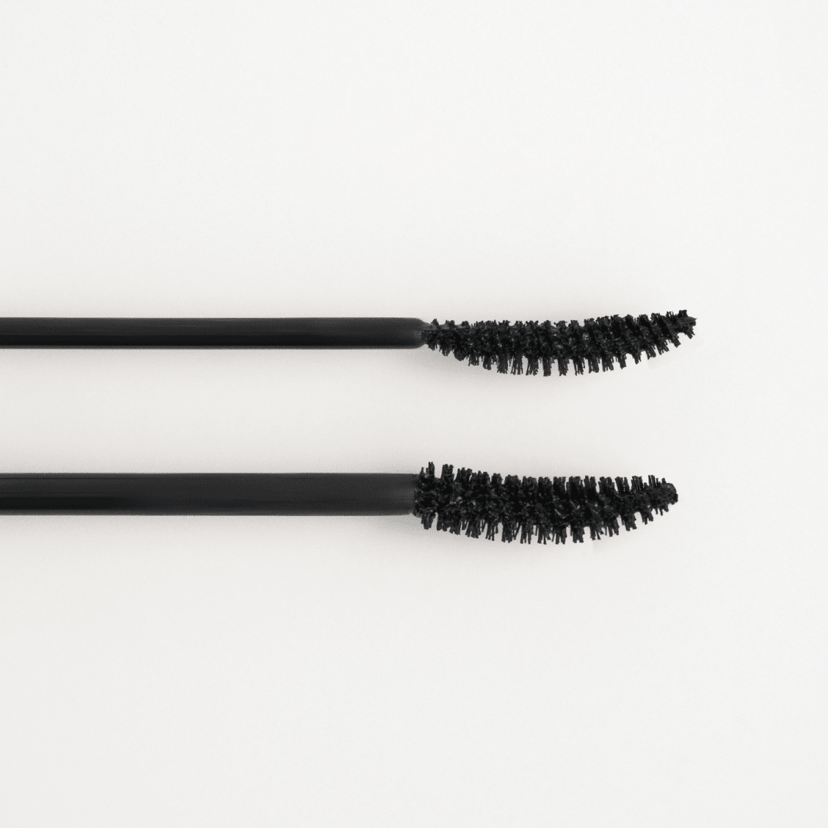 Peripera Ink All Black Cara mascara wand with black mascara formula, showing long, defined lashes for bold eye makeup.