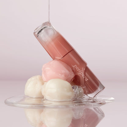 Peripera Ink Mood Glowy Tint lip tint in Tteok Recipe with a glossy, vibrant pink shade displayed on the lips.