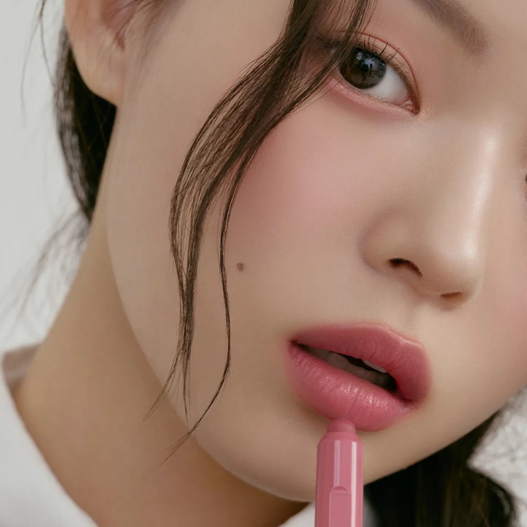 Peripera Slip On My Lip lipstick in a sleek tube with vibrant pink color, ready for easy application and smooth lip color.