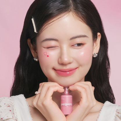Peripera Syrupy Tok Cheek blush in a soft, blendable shade with a glossy, syrup-like finish displayed on the cheek.