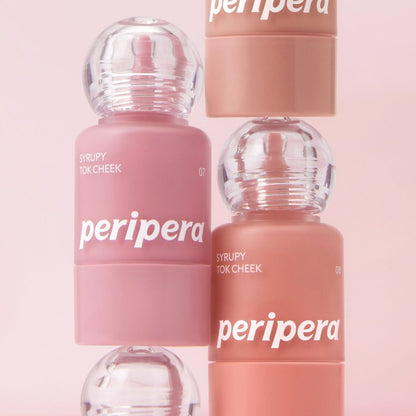Peripera Syrupy Tok Cheek blush in a soft, glossy pink shade displayed on a makeup palette.