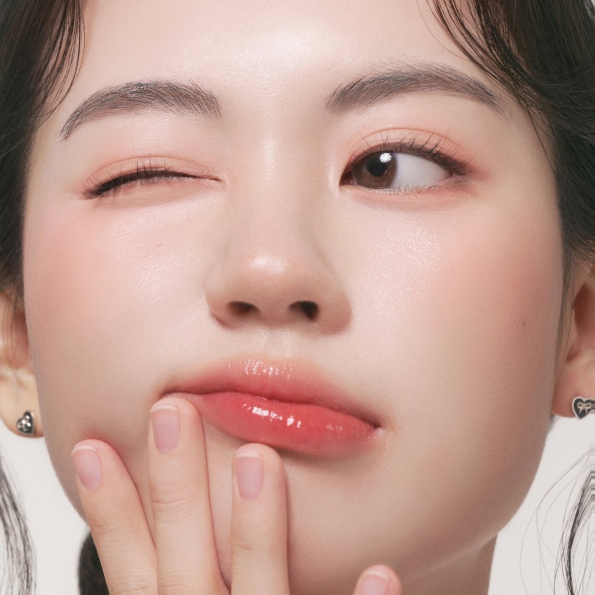 Peripera Syrupy Tok Cheek blush in a soft, glossy pink shade, with a smooth, creamy texture and subtle shimmer finish.