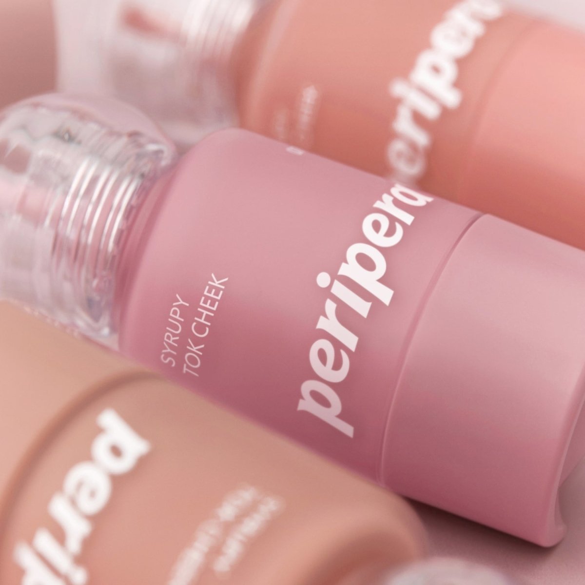 Peripera Syrupy Tok Cheek blush in a soft, syrupy pink shade, with a smooth, creamy texture and adorable packaging.